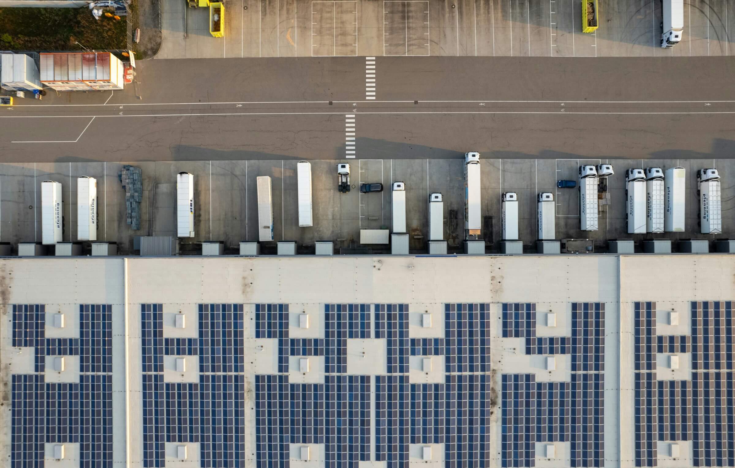 Aerial view of a warehouse with trucks backing into the building